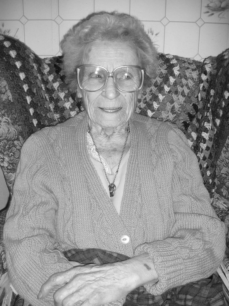 monochrome photo of a smiling old lady
