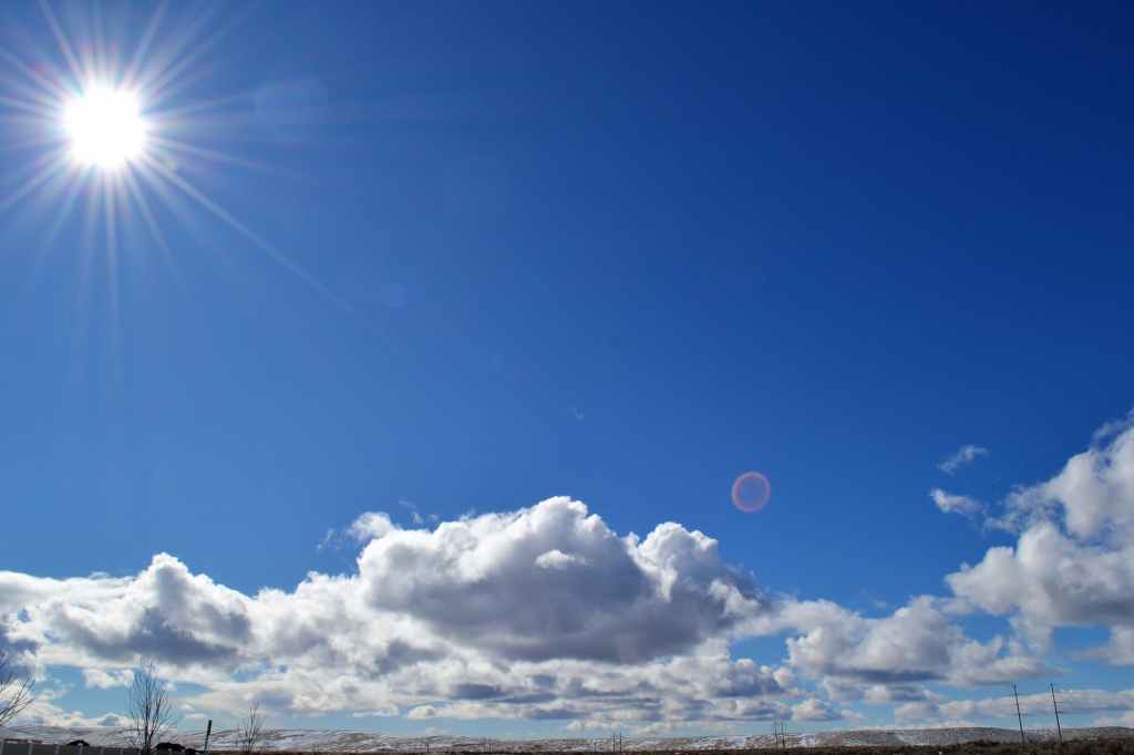 sun shining in a blue sky