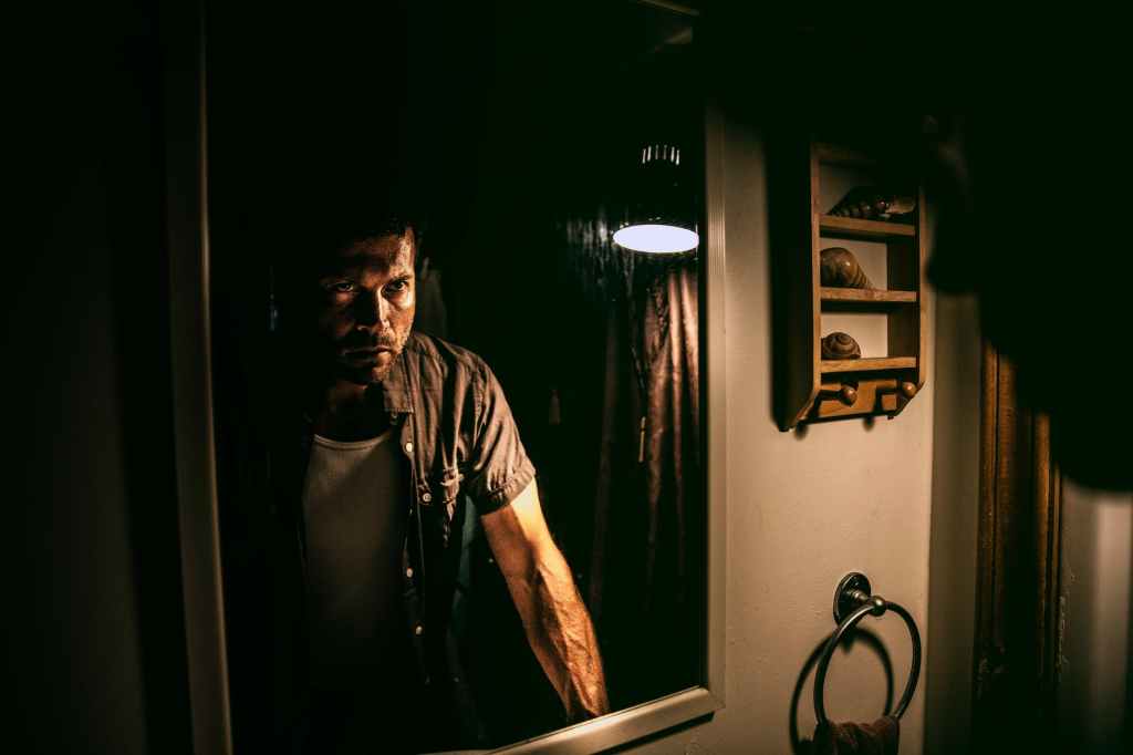 man standing in front of mirror