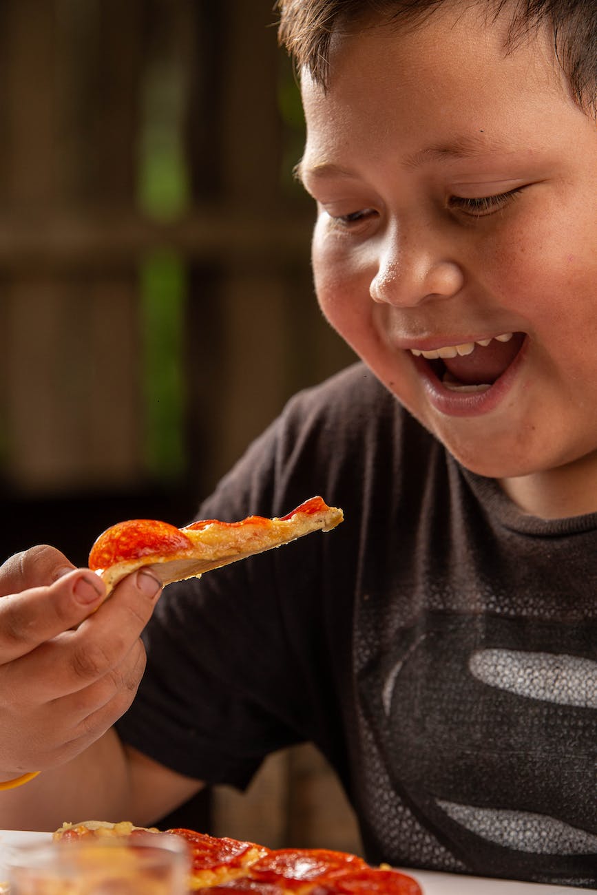 smiling boy with pizza